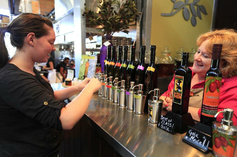 A woman samples a number of olive oil flavors at the Olive Press tasting room in Napa, Calif. 