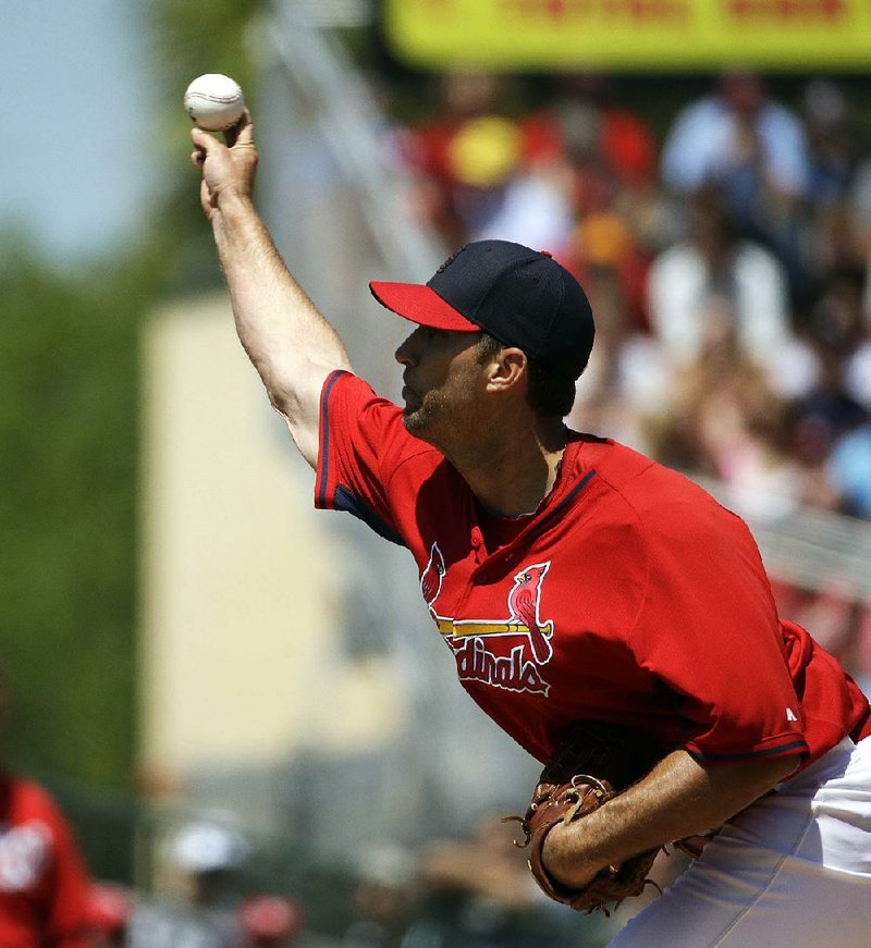 St. Louis Cardinals starting pitcher Adam Wainwright throws in the second inning of an exhibition spring training baseball game against the Washington Nationals, Wednesday, March 26, 2014, in Jupiter, Fla. (AP Photo/David Goldman)