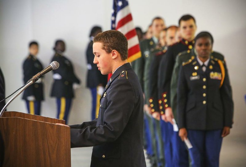 3/29/14
Arkansas Democrat-Gazette/STEPHEN B. THORNTON
North LIttle Rock High School ROTC cadet Noah Jones, left, take his turn reading the names of Arkansas soldiers killed in Iraq and Afghanistan as other students, right, wait to read, during the 9th annual Tribute to Fallen Heroes Ceremony Saturday afternoon in North Little Rock. The event was sponsored by the Michael Vann Johnson, Jr. American Legion Post #74 of North Little Rock.
