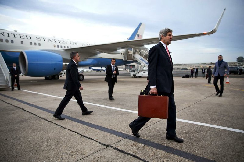 Secretary of State John Kerry rushes from his plane Saturday at the Paris airport after changing his travel plans to hold talks today on Ukraine with Russian Foreign Minister Sergey Lavrov. 