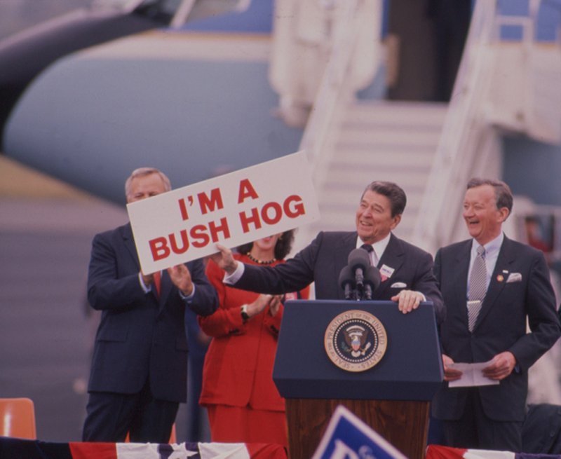 Arkansas Democrat-Gazette/Clay Carson President Ronald Reagan holds a sign in Little Rock in 1988 as he campaigned for Vice President George Bush.