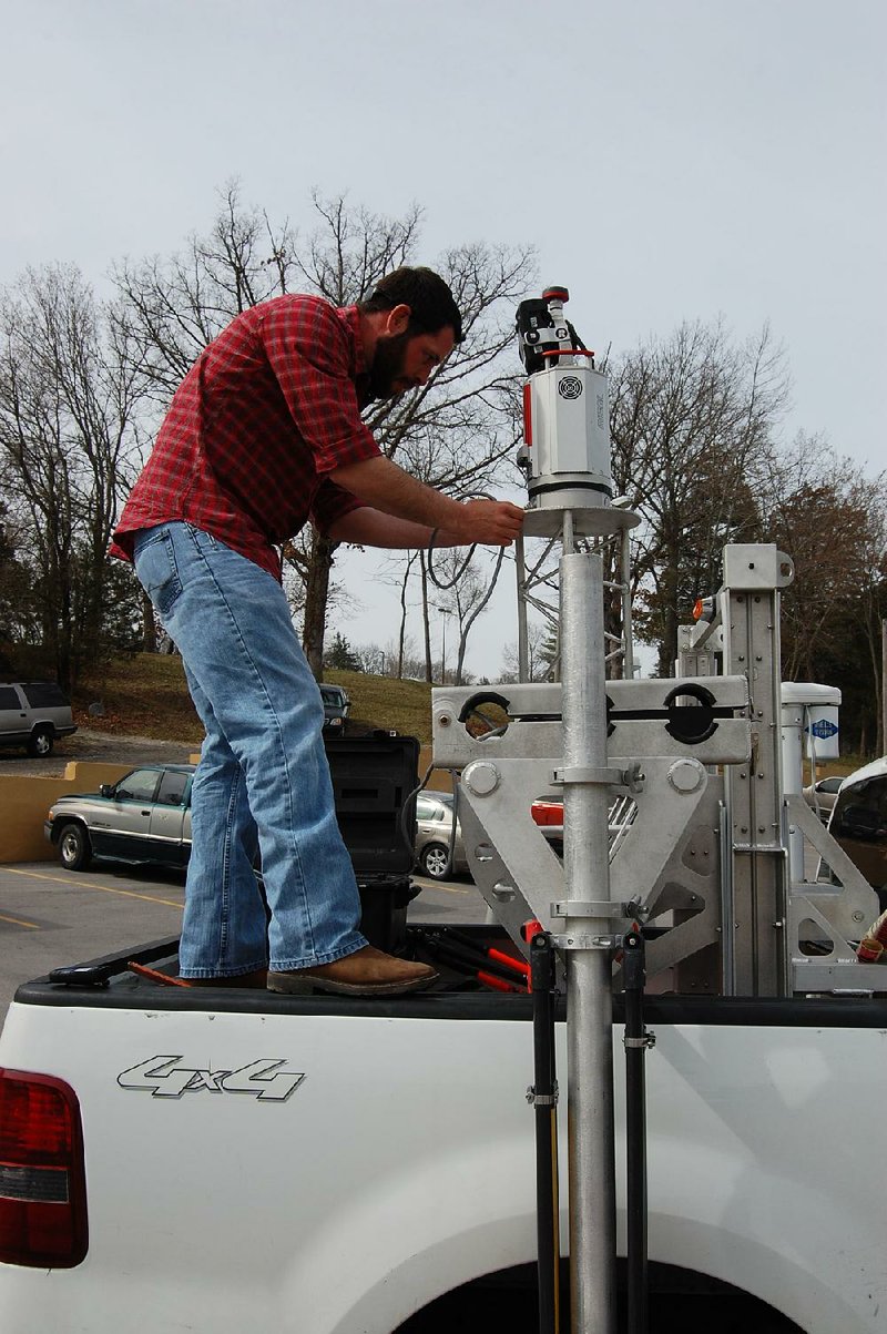 Kyle Madrid, survey field chief with CFS Engineering sets up a LiDAR scanner in Branson, Mo. on Friday, March 21.  The city is using the technology to map its vital U.S. Highway 76 corridor. Photo by John Magsam