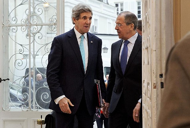 U.S. Secretary of State John Kerry, left, is greeted by Russian Foreign Minister Sergey Lavrov at the Russian Ambassador's Residence to discuss the situation in Ukraine, in Paris, Sunday March 30, 2014. Kerry traveled to Paris for a last minute meeting with Lavrov. (AP Photo/Jacquelyn Martin, Pool)