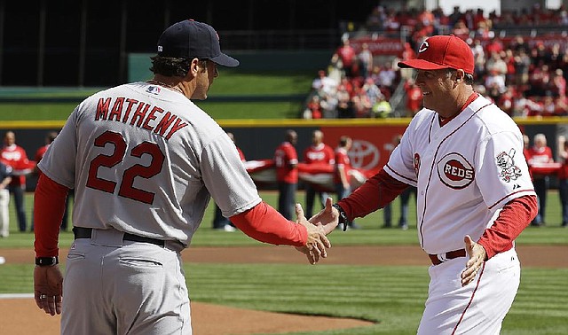 St. Louis Cardinals manager Mike Matheny (22) and manager Bryan Price shakes hands at the start of a baseball game, Monday, March 31, 2014, on opening day in Cincinnati. (AP Photo/Al Behrman)