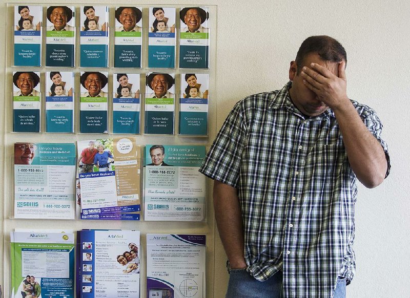 Applicant Daniel Padilla, 34, waits during a health care enrollment event at AltaMed Health Insurance Resource Center, Monday, March 31, 2014, in Los Angeles. Monday is the open enrollment deadline for signing up for insurance under the health care act. (AP Photo/Ringo H.W. Chiu)