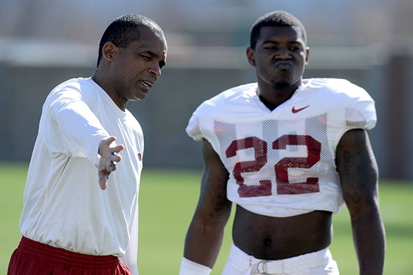  Arkansas senior associate head coach Randy Shannon directs linebacker Otha Peters during practice Thursday, March 20, 2014, at the UA practice field in Fayetteville.