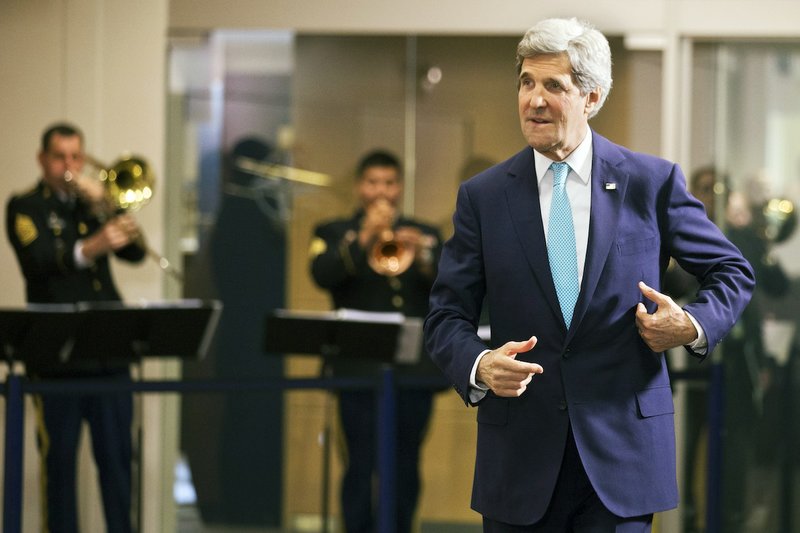 U.S. Secretary of State John Kerry walks through NATO headquarters after attending a NATO Enlargement Anniversary Ceremony with NATO Foreign Ministers in Brussels Tuesday April 1, 2014.