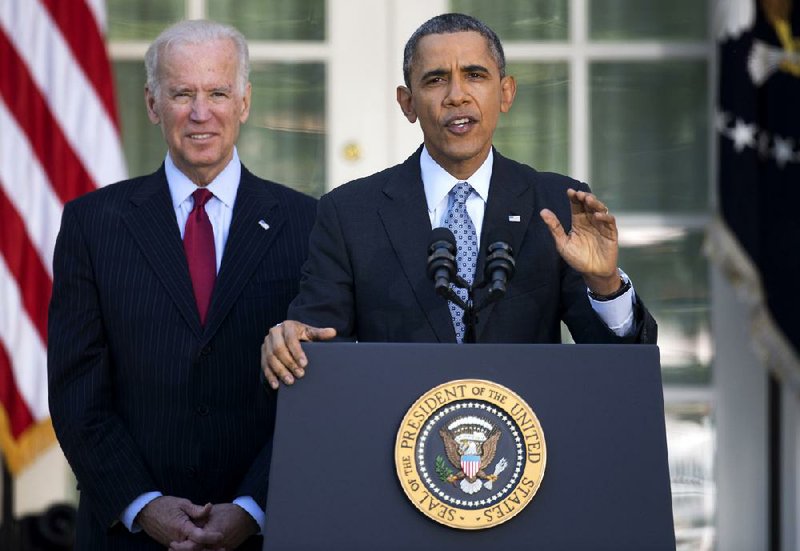 Vice President Joe Biden and President Barack Obama announce health-insurance sign-up numbers Tuesday at the White House. “The debate over repealing this law is over,” Obama said. 
