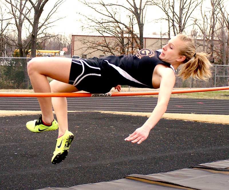 File Photo by Randy Moll Gravette junior, Kylee Davis, just clears the bar during high jump competition last season.