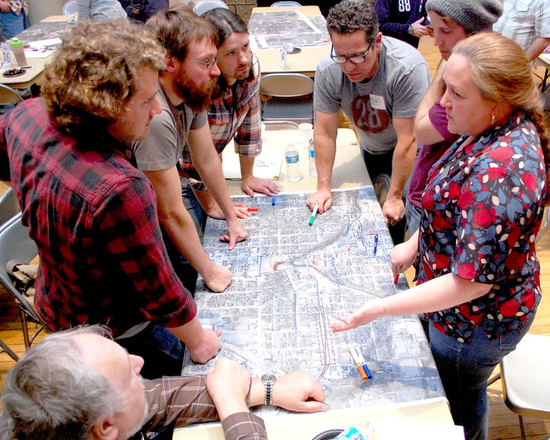 Jeff Della Rosa/Herald-Leader Shawn Hunter, right, owner of Inuendos Sign Co., speaks to members of her group as they identify areas of importance in the downtown area during the first of two public meetings this week for the downtown master plan. People interested in the downtown master plan split off into groups to talk about ideas they have for downtown and the surrounding area.