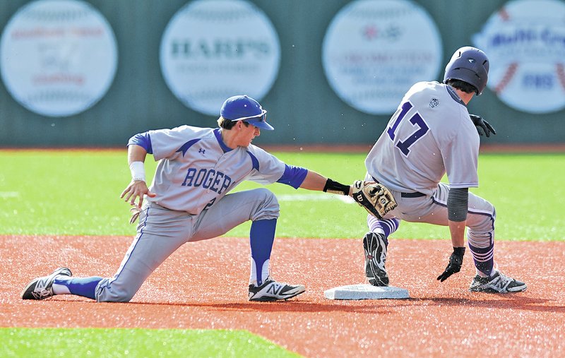  STAFF PHOTO ANDY SHUPE Fayetteville's Blake Power, right, comes in safely at the bag Tuesday as Rogers High shortstop Timmy Seldomridge applies the late tag during the Bulldogs'; six-run second inning at Fayetteville.