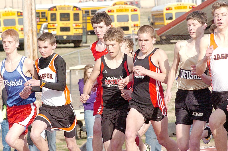 RICK PECK MCDONALD COUNTY PRESS McDonald County&#8217;s Wesley Bethel (left) and Wade Schmit battle for position at the start of the 1600 meter run at the Mustang Stampede held March 27 at McDonald County High School.