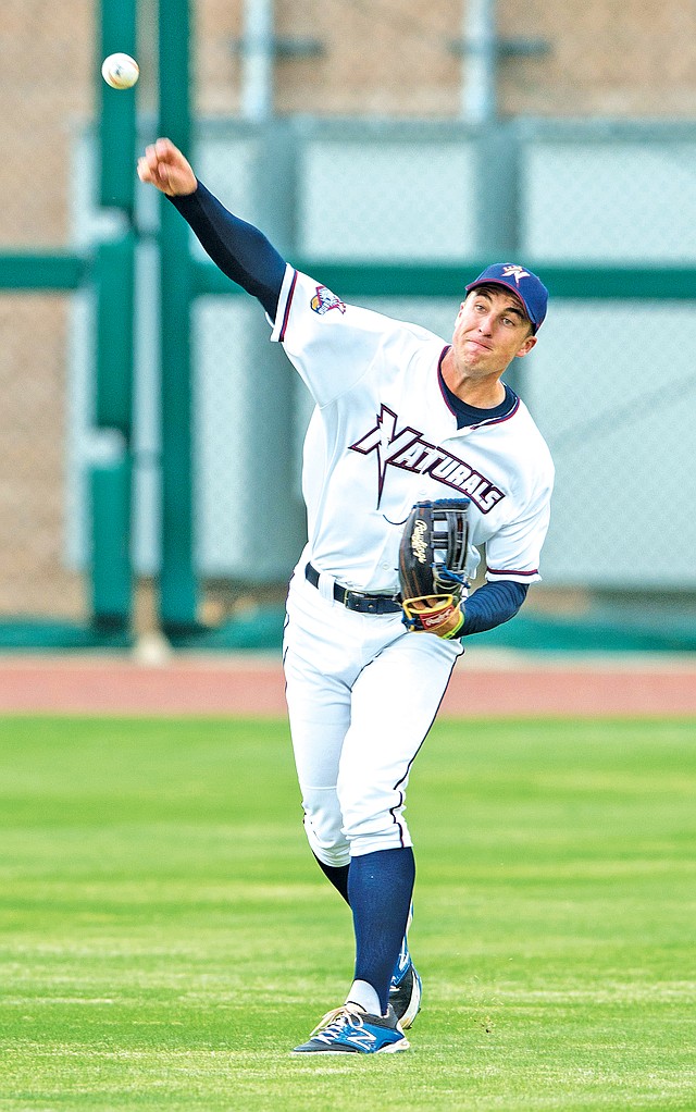 STAFF PHOTO ANTHONY REYES Lane Adams, Northwest Arkansas Naturals outfielder, throws to the infield Monday at Arvest Ballpark in Springdale.