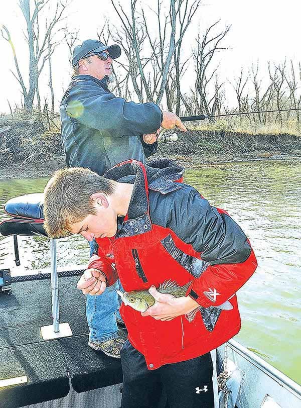  STAFF PHOTO FLIP PUTTHOFF 
Noah Conklin unhooks a white bass, one of several the 14-year-old caught while he and his dad, Jon Conklin, fished on Friday on the White River in the Arkansas 45 bridge area. The trip produced a species smorgasboard that included walleye, crappie and white bass.