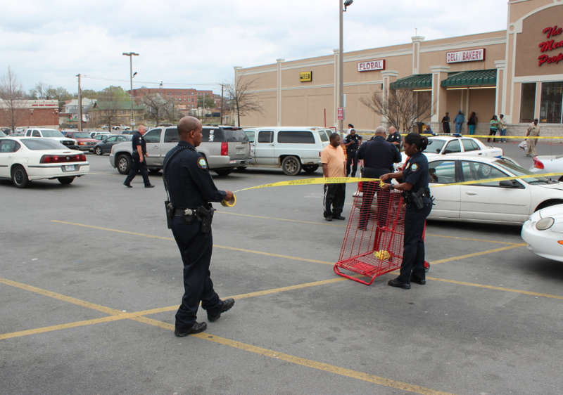 Police rope off a crime scene after shots rang out in the parking lot of a Little Rock grocery store Thursday.
