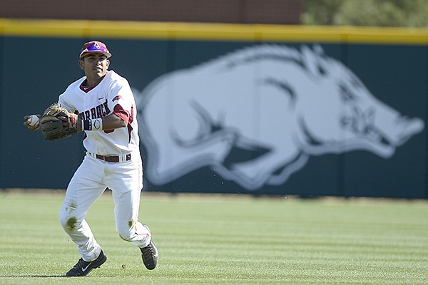 Arkansas shortstop Michael Bernal looks to throw after keeping the ball in the infield against Mississippi Valley State Tuesday, March 25, 2014 at Baum Stadium in Fayetteville. 