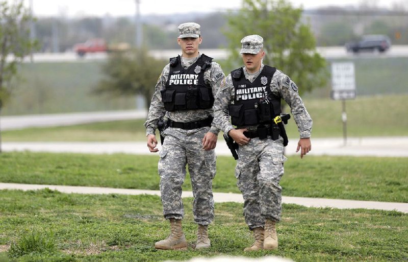 Military police patrol near the main gate Thursday at Fort Hood, Texas. A soldier, Spc. Ivan Lopez, opened fire Wednesday on fellow service members at the military post, killing three people and wounding 16 before committing suicide. 