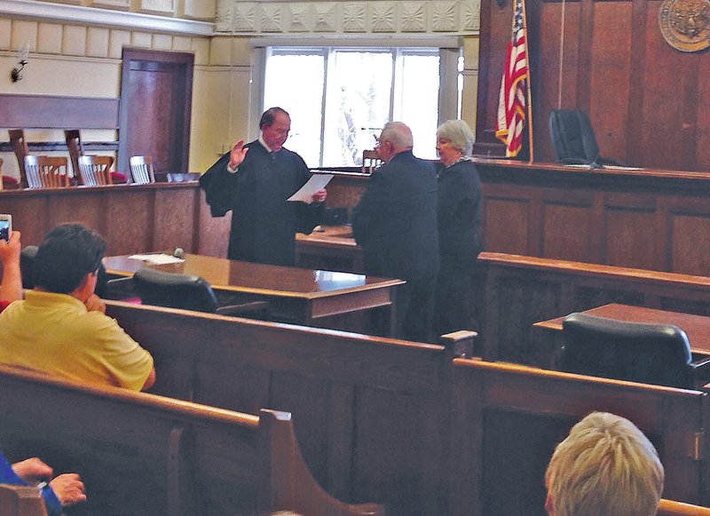 Staff Photo Tracy Neal Jim Clark was appointed Thursday to replace Van Stone as Benton County prosecutor. Clark was sworn in by retired Circuit Judge David Clinger. Clark&#8217;s wife, Sharon, stood next to her husband during the ceremony.