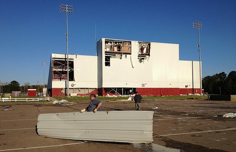 Workers clean up storm damage at Camden Fairview High School on Friday, April 4, 2014.