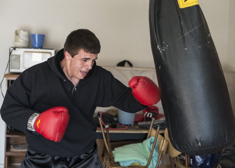  STAFF PHOTO ANTHONY REYES Thomas Sloman of Rogers works out Friday at his home in Rogers. Sloman recently won the 178-pound weight division of the Arkansas Gold Gloves Boxing Championships.