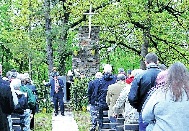 File Photo Ray Boudreaux leads the congregation in singing in 2012 at the end of the annual Easter sunrise service at Mount Sequoyah Retreat and Conference Center in Fayetteville. Churches throughout Northwest Arkansas have special services planned for Holy Week and Easter.