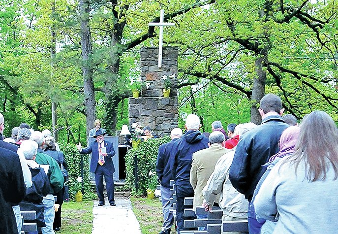 File Photo Ray Boudreaux leads the congregation in singing in 2012 at the end of the annual Easter sunrise service at Mount Sequoyah Retreat and Conference Center in Fayetteville. Churches throughout Northwest Arkansas have special services planned for Holy Week and Easter.