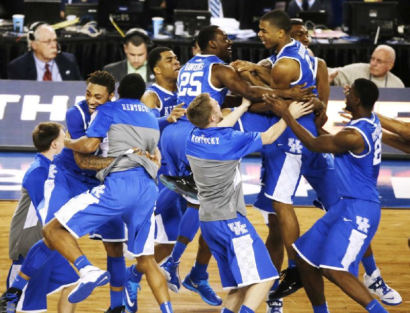 Kentucky celebrates after guard Aaron Harrison made a three-point shot in the final seconds as the Wildcats defeated Wisconsin 74-73 in the second NCAA Tournament semifinal Saturday at AT&T Stadium in Arlington, Texas. 