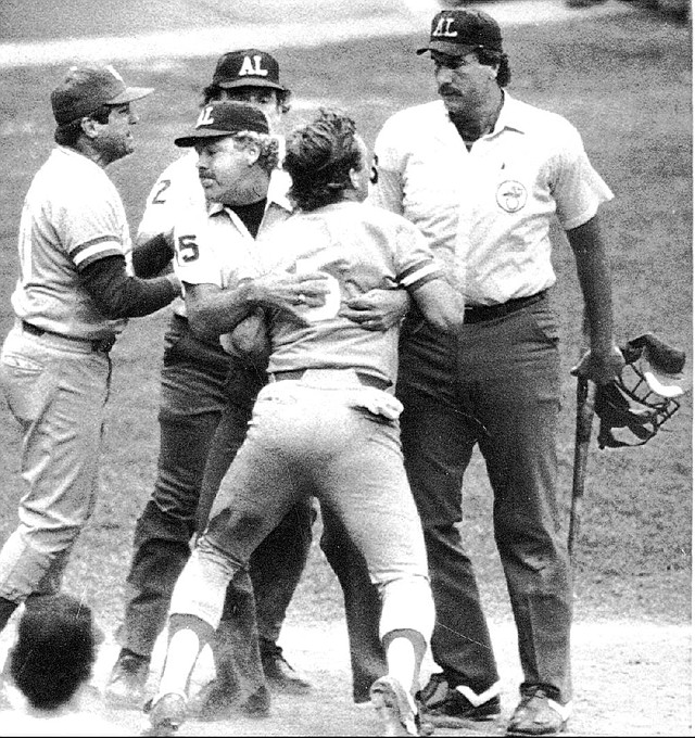 Kansas City third baseman George Brett (5) is restrained by umpire Joe Brinkman after Tim McClelland (right) ruled Brett’s bat was illegal because of the pine tar involved in a July 1983 game. McClelland, the majors’ second longest-tenured umpire, will miss this season because of back surgery. Despite several World Series and other notable moments, McClelland is best known for Brett and pine tar. 
