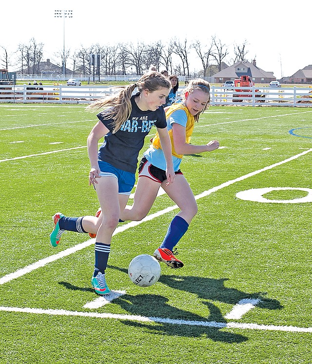  Special To NWA Media Skot Lindstedt Evie Cannon, left, Springdale Har-Ber soccer player practices with a teammate on Friday.