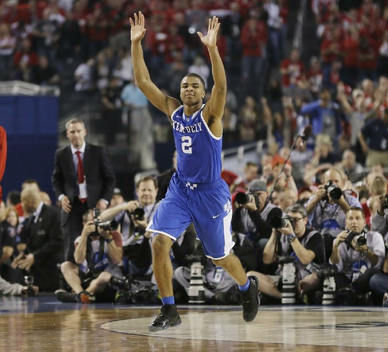 Kentucky guard Aaron Harrison (2) celebrates after making a three-point basket in the final seconds against Wisconsin to win the game 74-73 during their NCAA Final Four tournament college basketball semifinal game Saturday, April 5, 2014, in Arlington, Texas. (AP Photo/Charlie Neibergall)