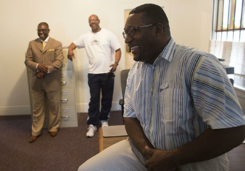 Arkansas Democrat-Gazette/MELISSA SUE GERRITS - 04/02/2014 - Director Barry Jefferson, front, with back left, Pastor Jerry Warren of Greater Christ Temple, and executive director of the CDC, Keith Fulks, speak about the new Youth Education Opportunity Center on 12th Street April 2, 2014. The center had a soft opening and is preparing to fully renovate the building as they create a space for their programs. 