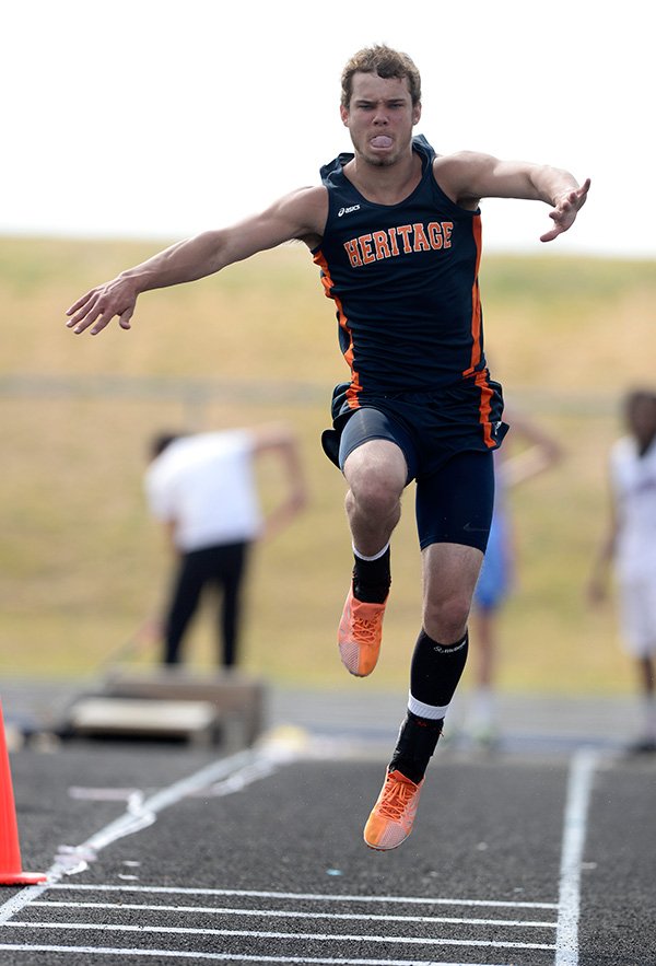 STAFF PHOTO ANTHONY REYES 
Daniel Spickes of Rogers Heritage competes in the triple jump on Tuesday during the Whitey Smith Relays Carnival track meet at the Whitey Smith Stadium in Rogers.