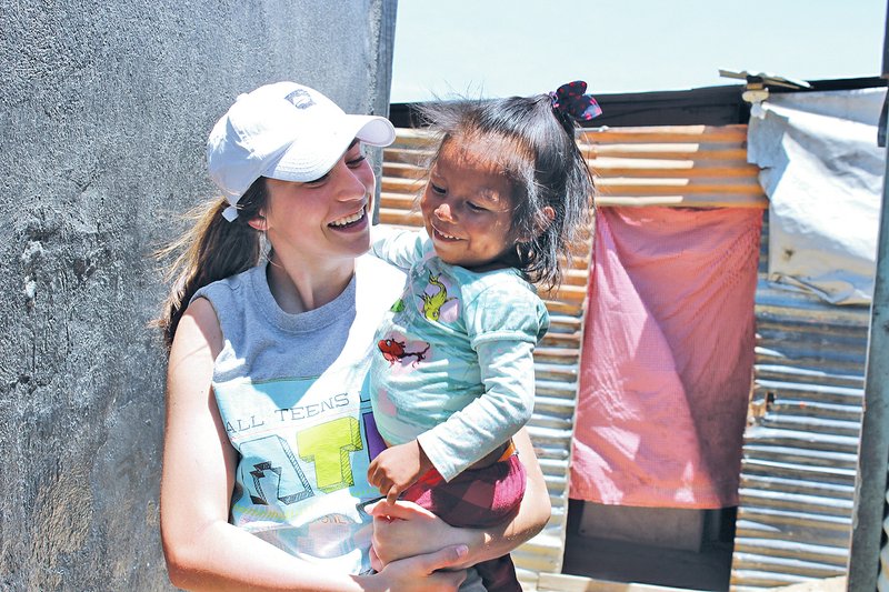Courtesy the Benton County Boys & Girls Club
Victoria Golden, 18, holds a child in a Guatemalan slum. Five members of Keystone Club at the Boys & Girls Club of Benton County visited Guatemala City and Chimaltenango during spring break.