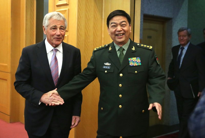 Defense Secretary Chuck Hagel shakes hands with Chinese Minister of Defense Chang Wanquan before their meeting at the Chinese Defense Ministry headquarters in Beijing on Tuesday, April 8, 2014. 