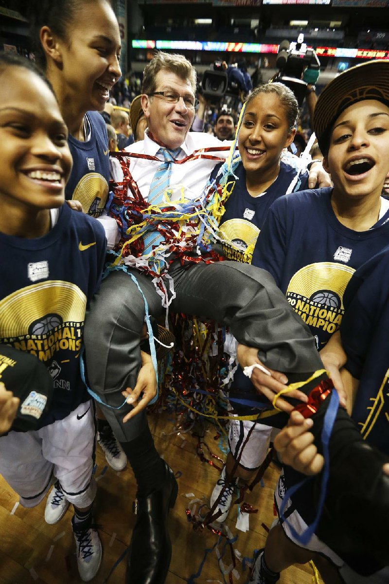 Coach Geno Auriemma is carried off the floor by Connecticut players following their national championship victory over Notre Dame on Tuesday in Nashville, Tenn. Connecticut completed a perfect 40-0 season as the Huskies won their ninth title under Auriemma. 