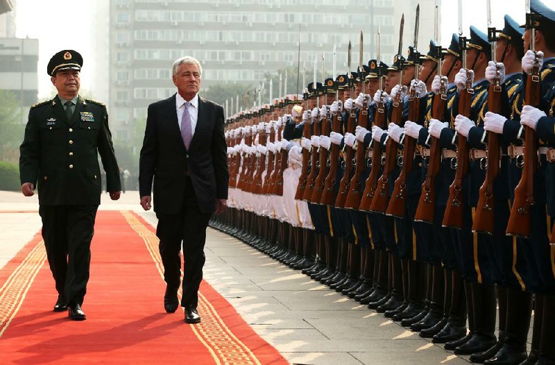 Chinese Defense Minister Chang Wanquan leads U.S. Defense Secretary Chuck Hagel in a review of an honor guard Tuesday at a welcoming ceremony at the Defense Ministry in Beijing. 