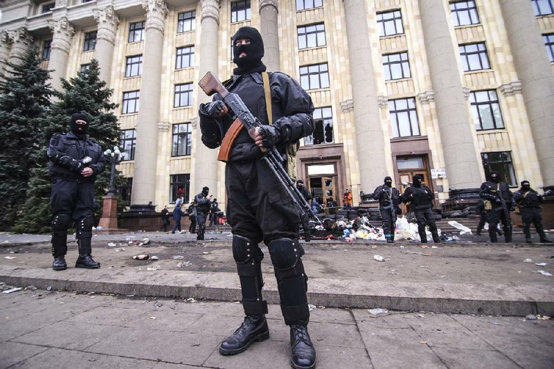 Members of a special police unit guard the regional administration building in Kharkiv, Ukraine, on Tuesday. 
