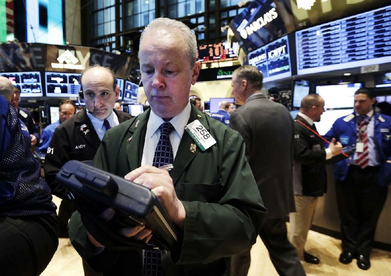 Trader James Riley (center), works Tuesday on the floor of the New York Stock Exchange. U.S. stocks rose Tuesday as technology stocks such as Google Inc. and Facebook Inc. rallied. 