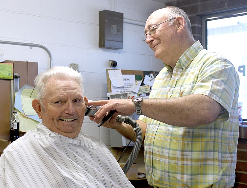 LYNN KUTTER ENTERPRISE-LEADER Eddie McClelland, right, is retiring after 48 years cutting hair as a barber in Prairie Grove. William Frederick said he's been coming to Jack's Barber Shop probably for almost 48 years. Customers come to the shop from all over, including Prairie Grove, Farmington, Fayetteville and even as far away as Springdale.