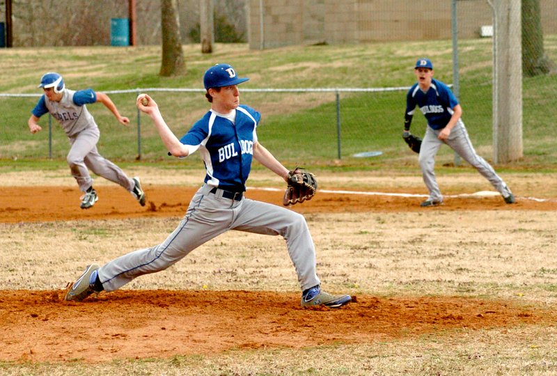 Photo by Mike Eckels Decatur pitcher Brody Funk begins his delivery just as a Westside Rebel runner attempts to steal second base during the April 1 game at Edmiston Park in Decatur. The runner was successful at his attempt.