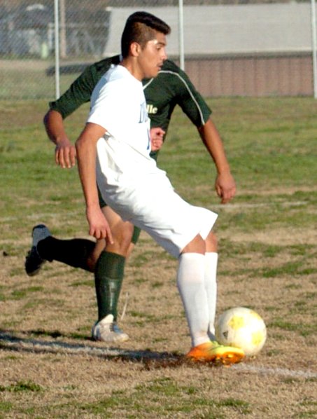 Photo by Mike Eckels Decatur's Antonio Rosales (#14) maneuvers the ball away from a Danville player in an attempt to set up a Bulldog score.