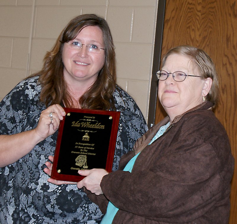 Photo by Dodie Evans Ida Wheeldon accepts a plaque from Sheila Roughton, food service director at the school.