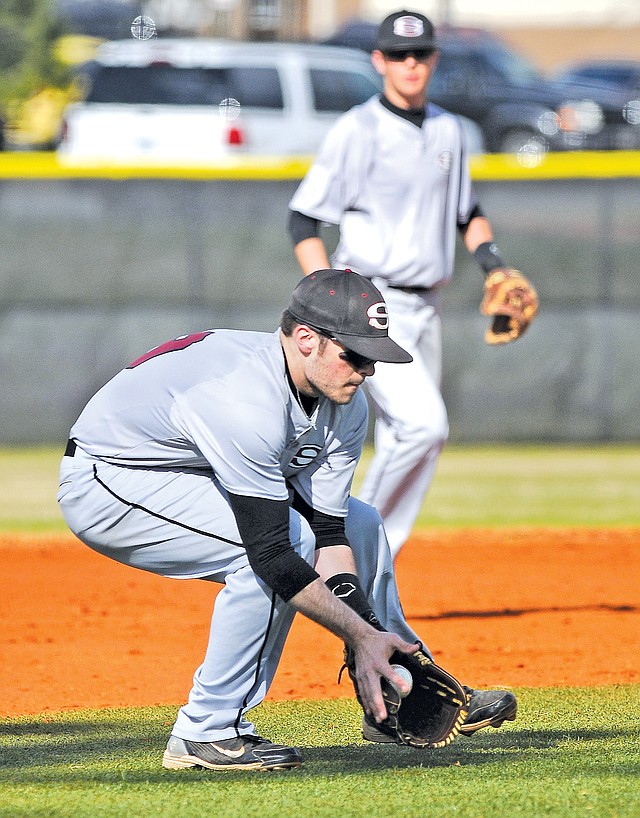  STAFF PHOTO BEN GOFF Josh Poulos, Springdale High third baseman, fields a ground ball Tuesday during Game 1 of the doubleheader against Bentonville at Bentonville's Tiger Athletic Complex.