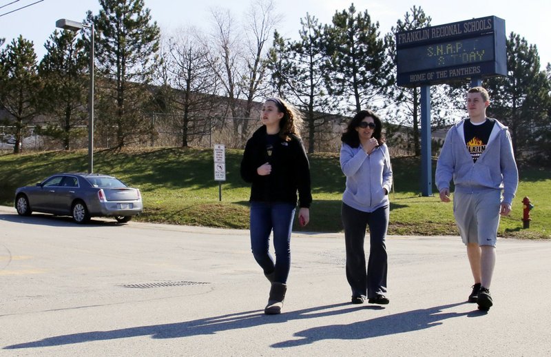 Students are escorted as they leave the campus of the Franklin Regional School District after more then a dozen students were stabbed by a knife wielding suspect at nearby Franklin Regional High School on Wednesday, April 9, 2014, in Murrysville, Pa., near Pittsburgh. The suspect, a male student, was taken into custody and is being questioned. 