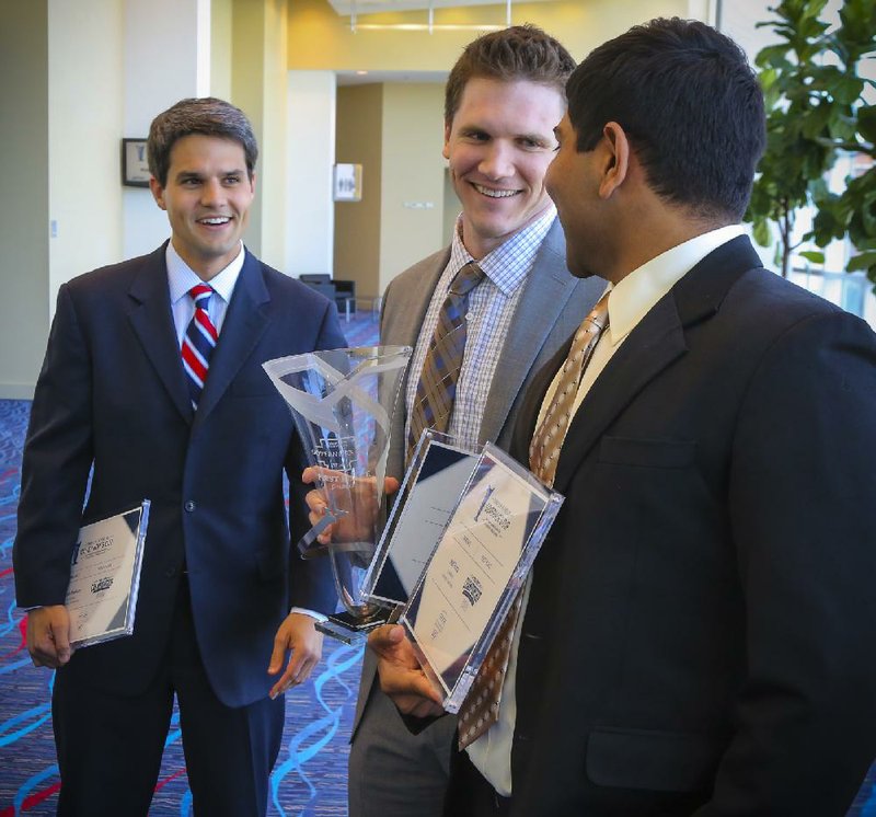 University of Arkansas graduate students Brad Phelan (from left), Joe Huff and Neil Bora talk Wednesday after winning the graduate student division of the Donald W. Reynolds Governor’s Cup competition at the Statehouse Convention Center in Little Rock. 