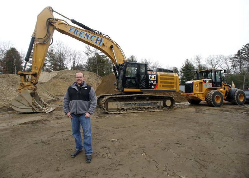 Bill French Jr., owner of W.L. French Excavating Corp., stands on his company property Monday in North Billerica, Mass. Behind him is equipment he bought with small-business tax breaks before they expired at the end of 2013. 