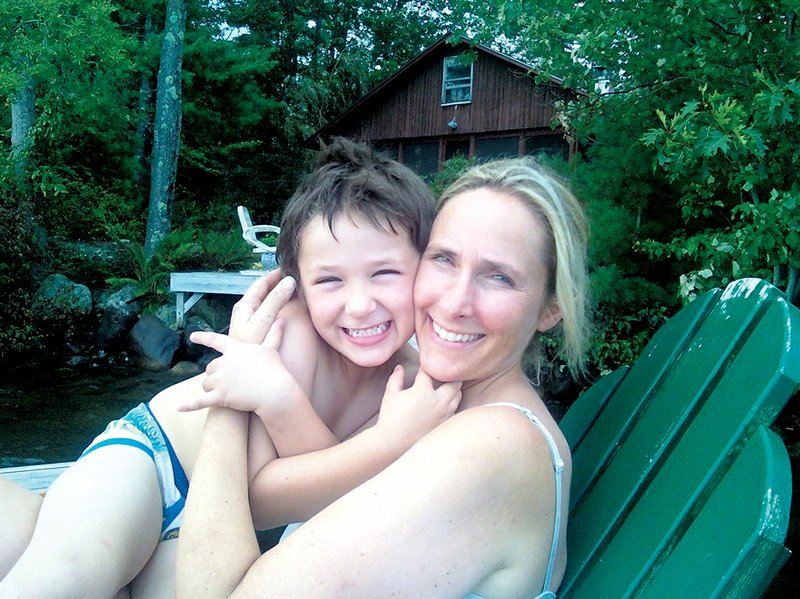 COURTESY PHOTO 
Jesse McCord Lewis hugs mom Scarlett near the pool at the family’s Connecticut home.