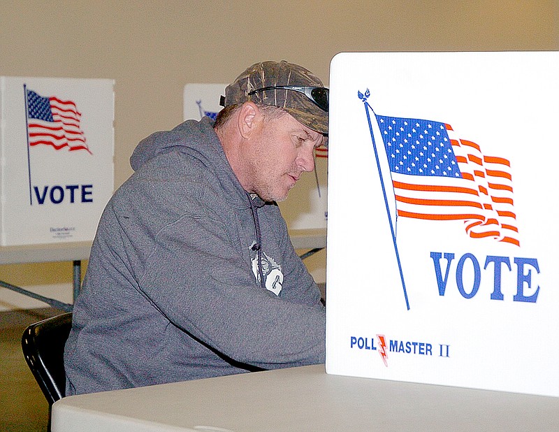 RICK PECK MCDONALD COUNTY PRESS Chris Roessler studies the ballot while voting at the Pineville Community Center during Tuesday's Municipal Election.