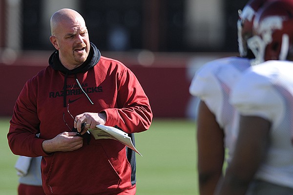 Arkansas defensive line coach Rory Segrest directs his players during practice Thursday, March 20, 2014, at the UA practice field in Fayetteville.
