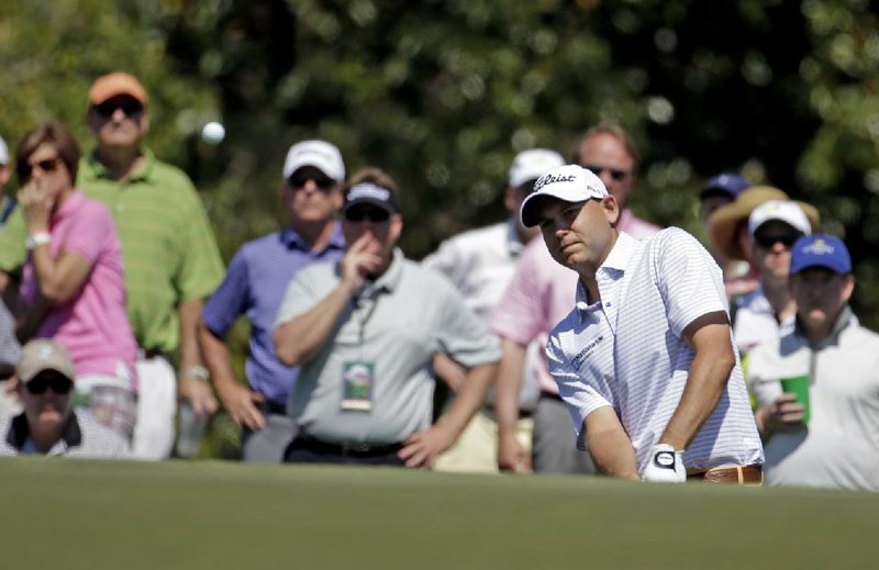 Bill Haas watches his chip shot to the 17th green during the first round of the Masters golf tournament Thursday, April 10, 2014, in Augusta, Ga. (AP Photo/Darron Cummings)